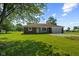 Charming single-story house with a well-manicured lawn, brick accents, covered porch, and attached garage in a rural setting at 10727 N Shupe Rd, Monrovia, IN 46157