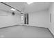 Large empty garage with white walls, gray flooring, overhead door system and lots of open space for cars or hobbies at 10727 N Shupe Rd, Monrovia, IN 46157