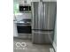 Modern kitchen featuring stainless steel appliances including range, microwave, and large refrigerator at 10727 N Shupe Rd, Monrovia, IN 46157