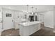 Modern kitchen with an island, stainless steel appliances, and bright white cabinets for an elegant and functional space at 10727 N Shupe Rd, Monrovia, IN 46157