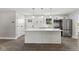 Beautiful kitchen features a large island, modern appliances, and white cabinets for a bright and airy space at 10727 N Shupe Rd, Monrovia, IN 46157
