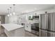 Bright kitchen features an island with quartz countertops, stainless steel appliances, and stylish pendant lighting at 10727 N Shupe Rd, Monrovia, IN 46157