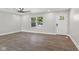 Bright, empty living room featuring modern floors, a ceiling fan, a large window, and a newly installed front door at 10727 N Shupe Rd, Monrovia, IN 46157