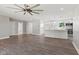 Open-concept living room flows into a kitchen with white cabinets and an island featuring pendant lighting at 10727 N Shupe Rd, Monrovia, IN 46157