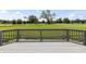 The gray wood back deck offers scenic views of the community golf course at 10753 Seaview Ln, Indianapolis, IN 46236