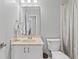 Bathroom featuring a vanity with a cream colored sink, toilet and striped shower curtain at 10753 Seaview Ln, Indianapolis, IN 46236