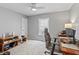 Bedroom with gray walls, neutral carpet, a ceiling fan, and a wooden desk at 10753 Seaview Ln, Indianapolis, IN 46236