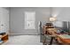 Bedroom featuring gray walls, neutral carpet, a wooden desk and a window at 10753 Seaview Ln, Indianapolis, IN 46236