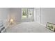 Bright bedroom featuring gray walls, neutral carpet, and two windows at 10753 Seaview Ln, Indianapolis, IN 46236