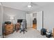 Bedroom featuring gray walls, neutral carpet, and a wooden desk at 10753 Seaview Ln, Indianapolis, IN 46236