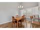 Bright dining room featuring a wooden table with seating for four and a chandelier at 10753 Seaview Ln, Indianapolis, IN 46236