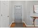 Inviting foyer with wood floors, grey walls, and a charming front door at 10753 Seaview Ln, Indianapolis, IN 46236