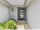 Close-up of the front door with sidelights and house number surrounded by lush greenery at 10753 Seaview Ln, Indianapolis, IN 46236