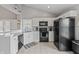 Modern kitchen features white cabinets, countertops, and black appliances at 10753 Seaview Ln, Indianapolis, IN 46236