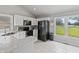 Bright kitchen with white cabinets, marble countertops and a large window overlooking the green yard at 10753 Seaview Ln, Indianapolis, IN 46236