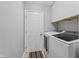 Laundry room with a pair of modern, front-loading washing machines at 10753 Seaview Ln, Indianapolis, IN 46236