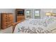 A well appointed main bedroom featuring a stylish comforter set, wood furniture, and plenty of natural light at 10753 Seaview Ln, Indianapolis, IN 46236