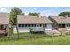 Charming backyard with a wood deck, lush greenery, and privacy fence at 10753 Seaview Ln, Indianapolis, IN 46236
