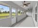 Relaxing screened porch with ceiling fans offers stunning views of the adjacent golf course at 10753 Seaview Ln, Indianapolis, IN 46236