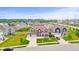 Aerial view of a residential neighborhood showcasing the house, green lawns, and surrounding landscape at 10811 Wild Orchard Ln, Indianapolis, IN 46239