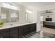A bathroom showing double vanity sinks, modern lighting, vinyl flooring, and shower at 10811 Wild Orchard Ln, Indianapolis, IN 46239