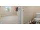 An empty secondary bedroom with a half bathroom showing a toilet and vinyl flooring at 10811 Wild Orchard Ln, Indianapolis, IN 46239