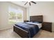 Comfortable bedroom with a ceiling fan, a large window, and an inviting bed at 10811 Wild Orchard Ln, Indianapolis, IN 46239