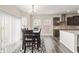 Dining room featuring a dining table and a view into the modern kitchen at 10811 Wild Orchard Ln, Indianapolis, IN 46239