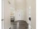Inviting foyer with dark plank floors and views into the living spaces at 10811 Wild Orchard Ln, Indianapolis, IN 46239