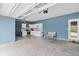 Spacious garage with blue accent wall, kitchen appliances, and a sitting bench at 10811 Wild Orchard Ln, Indianapolis, IN 46239