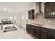 Close-up of modern kitchen featuring a large island, stainless steel hood, and ample counter space at 10811 Wild Orchard Ln, Indianapolis, IN 46239
