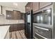Contemporary kitchen with stainless steel appliances, dark cabinetry, and sleek quartz countertops at 10811 Wild Orchard Ln, Indianapolis, IN 46239