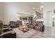 Spacious living room with theater seating, open to the kitchen, and featuring a decorative rug at 10811 Wild Orchard Ln, Indianapolis, IN 46239