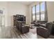 Open living room with high ceilings, large windows, and comfortable reclining seating at 10811 Wild Orchard Ln, Indianapolis, IN 46239
