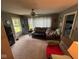 Cozy living room with neutral carpet, ceiling fan, and lots of natural light at 111 S Jefferson St, Brownsburg, IN 46112
