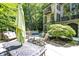 Back patio area featuring an outdoor seating area, spa, and lush greenery, perfect for relaxing and entertaining guests at 11557 Willow Springs Dr, Zionsville, IN 46077