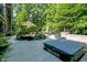 Relax in the private backyard with a hot tub and an outdoor lounge area with mature landscaping and room to roam at 11557 Willow Springs Dr, Zionsville, IN 46077