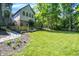 Manicured backyard with lush green lawn and access to an outdoor kitchen, ideal for recreation at 11557 Willow Springs Dr, Zionsville, IN 46077