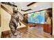 Finished basement hallway with decorative bear sculpture and world map accent wall at 11557 Willow Springs Dr, Zionsville, IN 46077