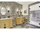 Elegant bathroom featuring dual sinks, ornate mirrors, and a glass-enclosed shower for a spa-like experience at 11557 Willow Springs Dr, Zionsville, IN 46077