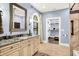 Detailed bathroom features an ornate mirror and a view into the walk-in closet at 11557 Willow Springs Dr, Zionsville, IN 46077