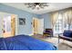Spacious bedroom boasts a ceiling fan, carpeted floors, and ample natural light at 11557 Willow Springs Dr, Zionsville, IN 46077