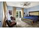 Stylish bedroom with a ceiling fan, carpeted floor, and patio access through french doors at 11557 Willow Springs Dr, Zionsville, IN 46077