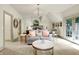 Stylish bedroom with sitting area, chandelier, and direct access to balcony through french doors at 11557 Willow Springs Dr, Zionsville, IN 46077