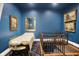 Bonus room with massage table and stair case to lower level, and three gold framed art pieces at 11557 Willow Springs Dr, Zionsville, IN 46077