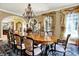 Formal dining room boasts large windows, hardwood floors, and seating for eight at 11557 Willow Springs Dr, Zionsville, IN 46077