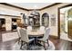 The dining room table sits on a large rug near the kitchen with granite counters and stainless steel appliances at 11557 Willow Springs Dr, Zionsville, IN 46077
