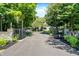 Gated entrance and long driveway leading to a large home, surrounded by lush landscaping at 11557 Willow Springs Dr, Zionsville, IN 46077