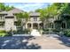 Stunning stone home featuring arched entry, balconies, and mature landscaping at 11557 Willow Springs Dr, Zionsville, IN 46077