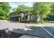 Impressive stone house with mature trees and a circular driveway provides privacy and a stately first impression at 11557 Willow Springs Dr, Zionsville, IN 46077